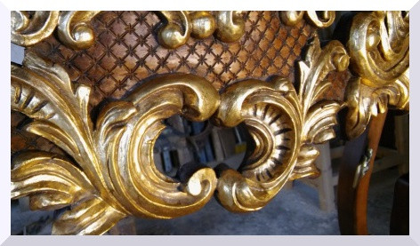 Detall de la talla daurada d'una consola barroca.